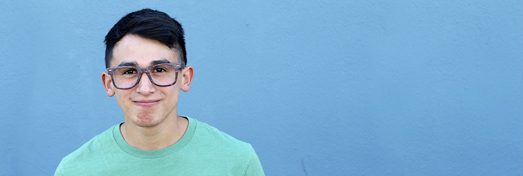 Young man smiling with glasses