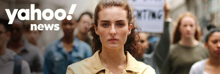 young redhead woman marching with yahoo news logo on top left